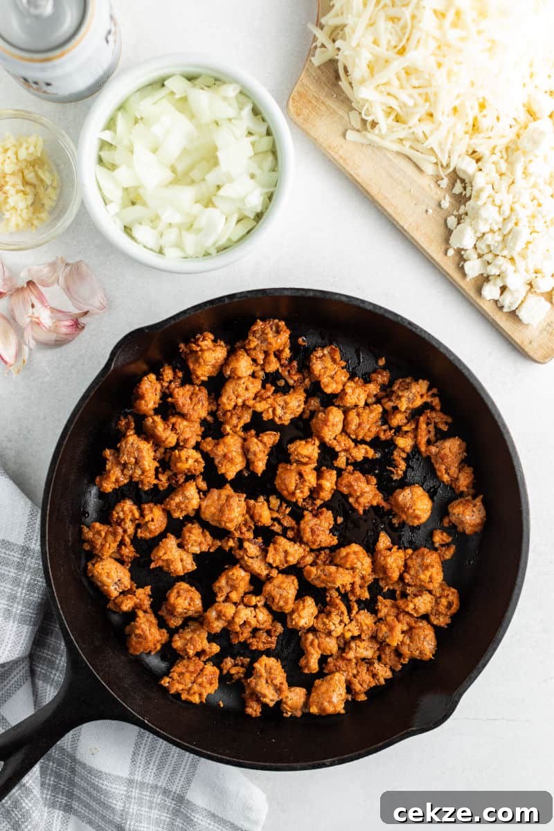 ingredients to make queso fundido with cooked chorizo in a skillet