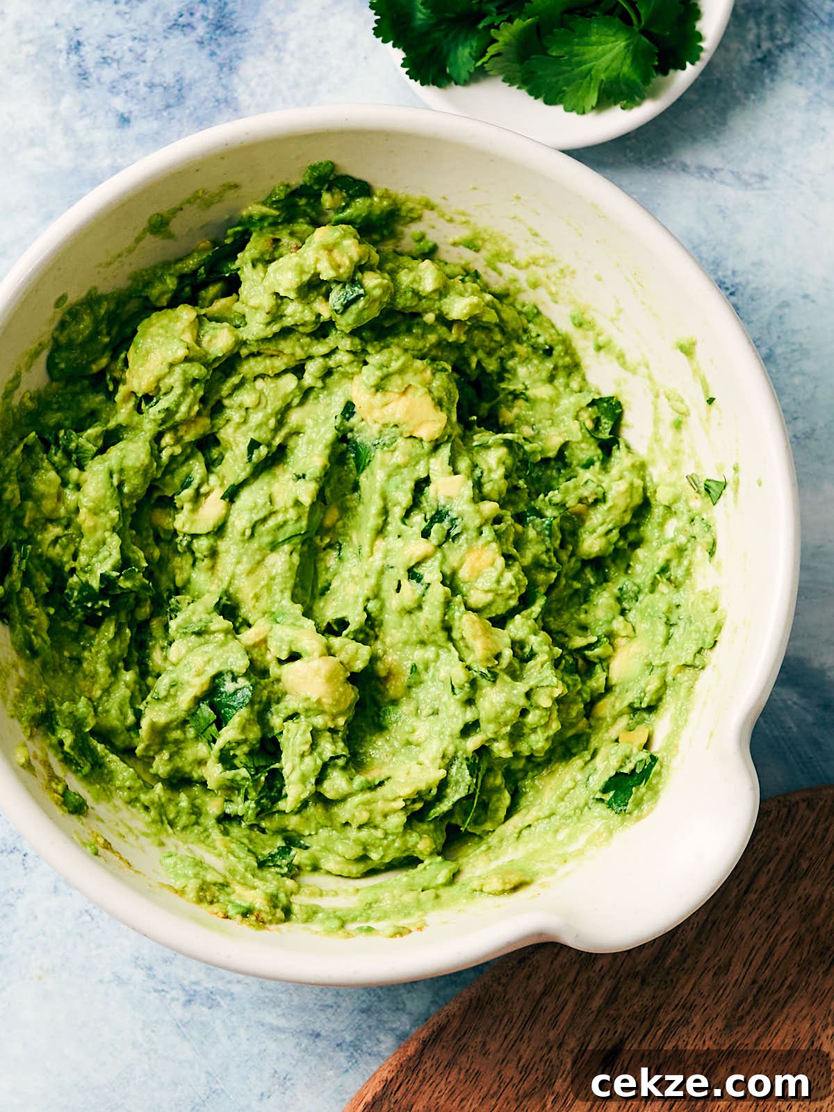 Best vegan guacamole in a serving bowl with cilantro.