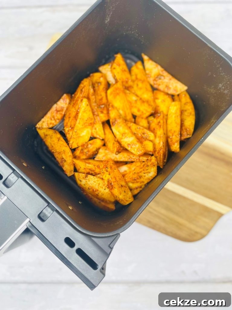 air fryer wedges with peri peri seasoning in the air fryer basket