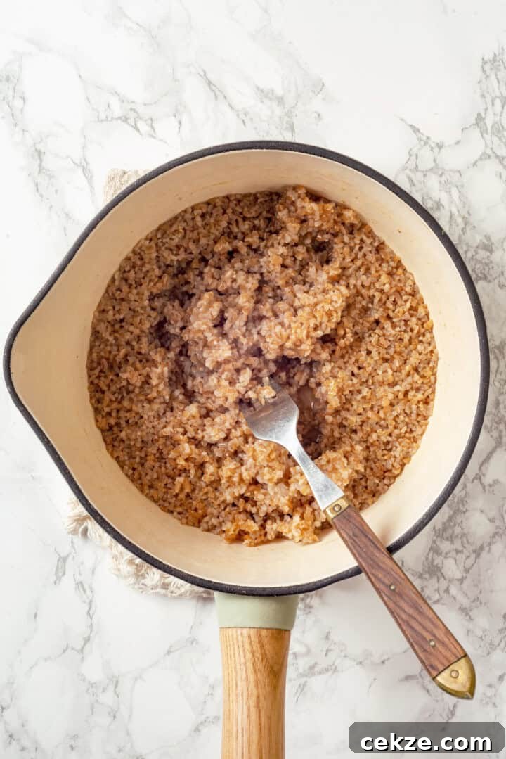 Overhead view of cooked bulgur in saucepan