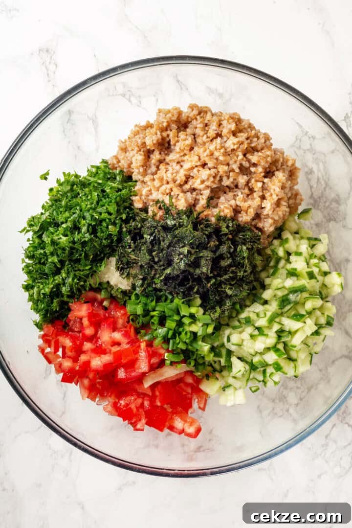 Overhead view of tabbouleh ingredients in mixing bowl