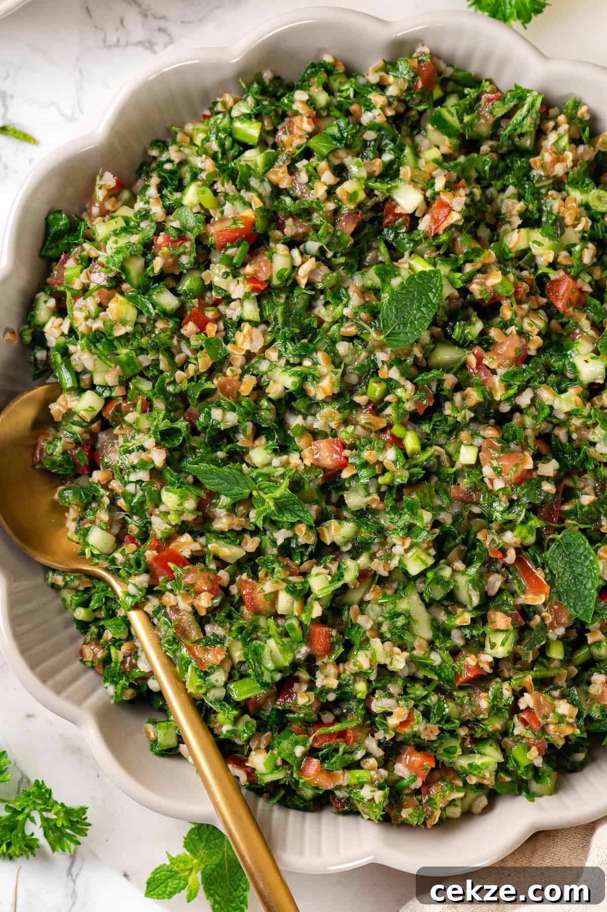 Overhead view of tabbouleh in serving bowl with spoon