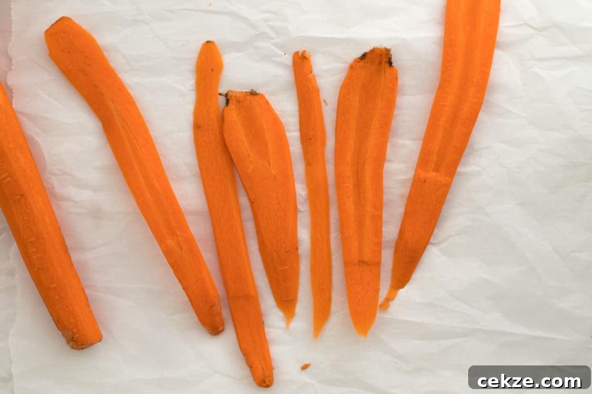 Crispy Bacon-Roasted Carrots with Maple Glaze 4 strips of carrots on parchment paper