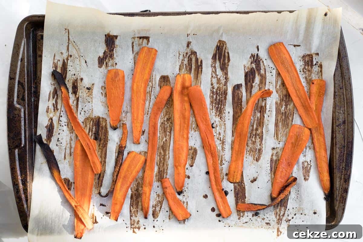 Crispy Bacon-Roasted Carrots with Maple Glaze 8 carrot bacon on a baking sheet just out of the oven