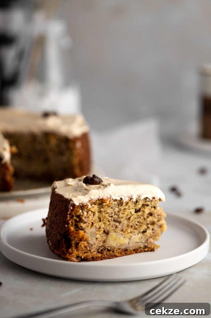 A slice of coffee and banana cake topped with espresso frosting.