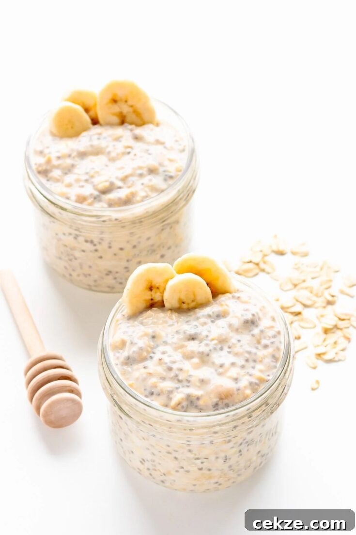 Two jars of banana overnight oats sitting on a white table.