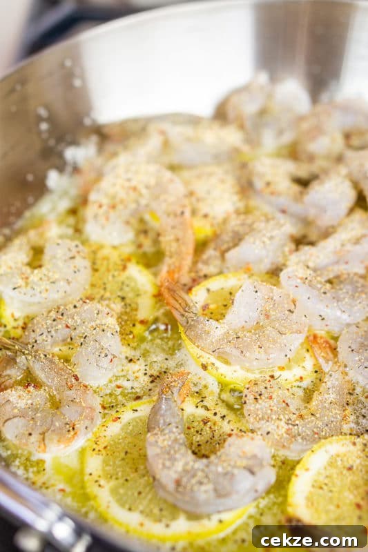 Garlic Butter Lemon Shrimp Recipe with Garlic-Parsley Sauce 7 Seasoned shrimp on top of lemons in a butter sauce.