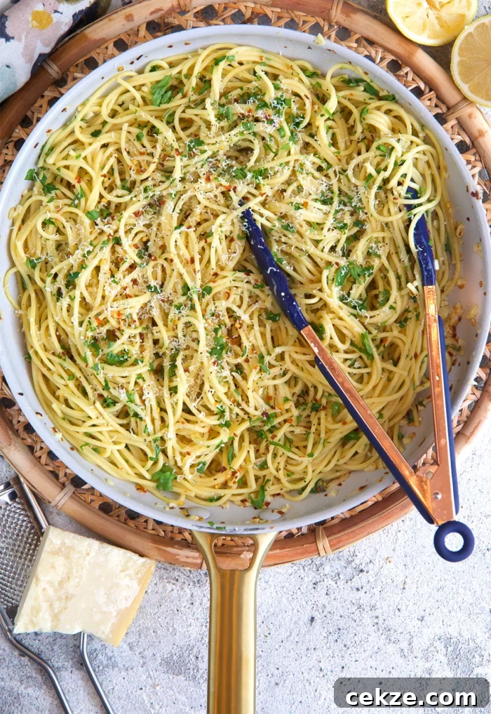 Classic Spaghetti Aglio e Olio: Simple Garlic Olive Oil Pasta Recipe 6 pasta aglio e olio in a skillet with tongs after being cooked.