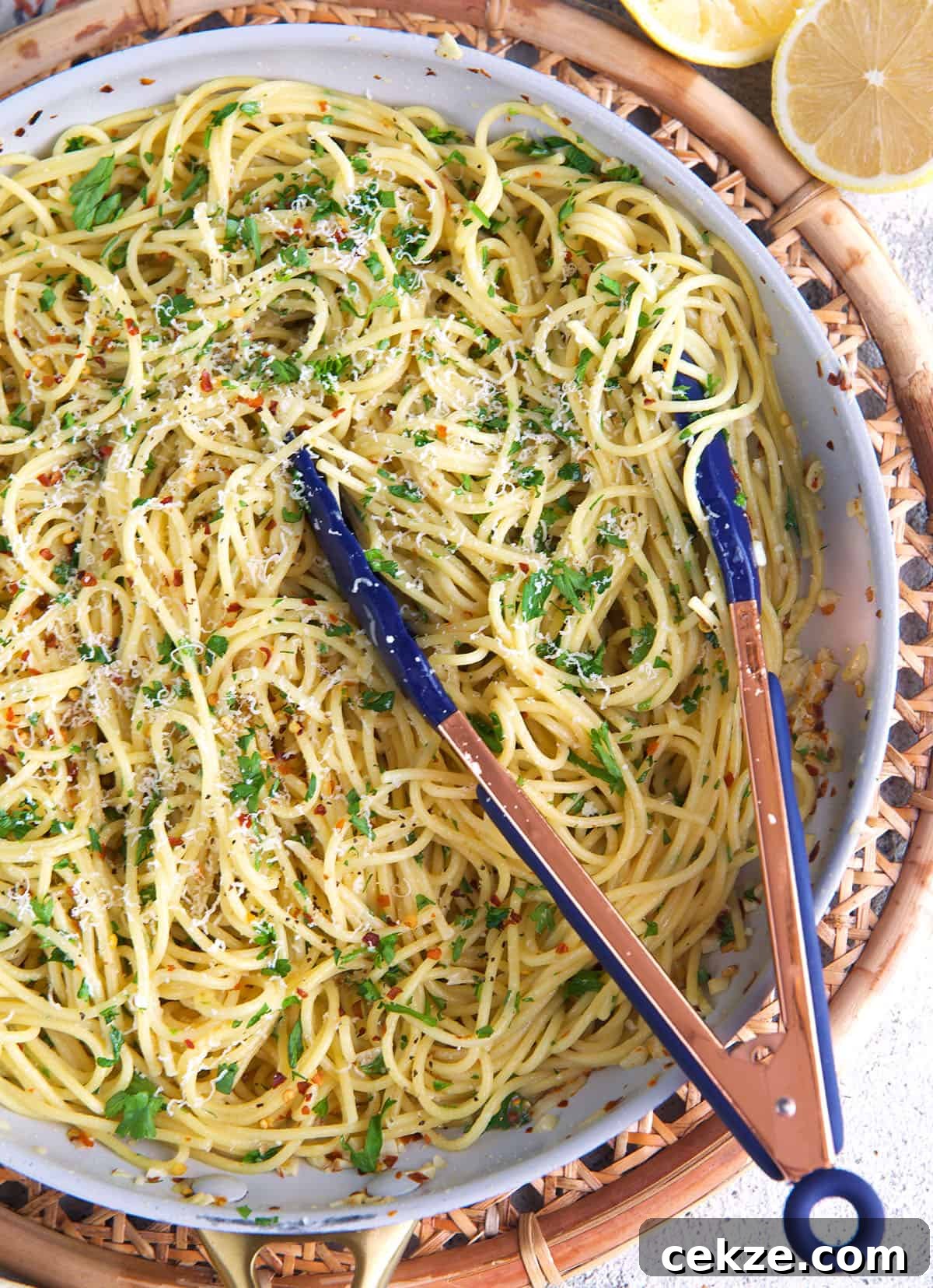Classic Spaghetti Aglio e Olio: Simple Garlic Olive Oil Pasta Recipe 7 spaghetti aglio e olio in a skillet with tongs.