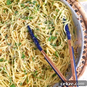 Classic Spaghetti Aglio e Olio: Simple Garlic Olive Oil Pasta Recipe 9 spaghetti aglio e olio in a skillet with tongs.