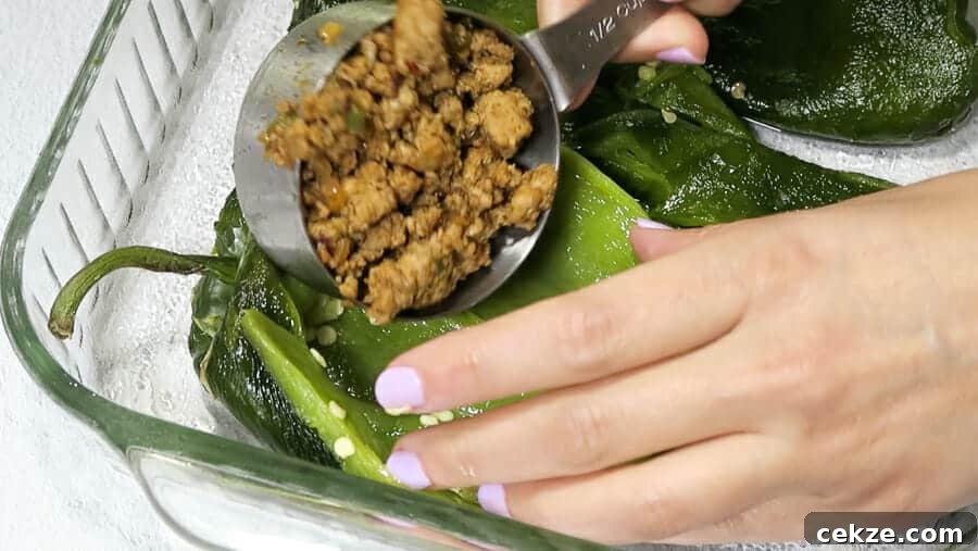 chiles rellenos being stuffed with ½ cup turkey taco meat