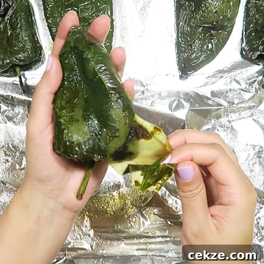 peeling the poblano chiles for the Easy Healthy Chile Rellenos baked with turkey taco meat 