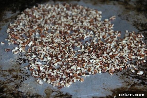 Chopped toasted pecans on a baking sheet