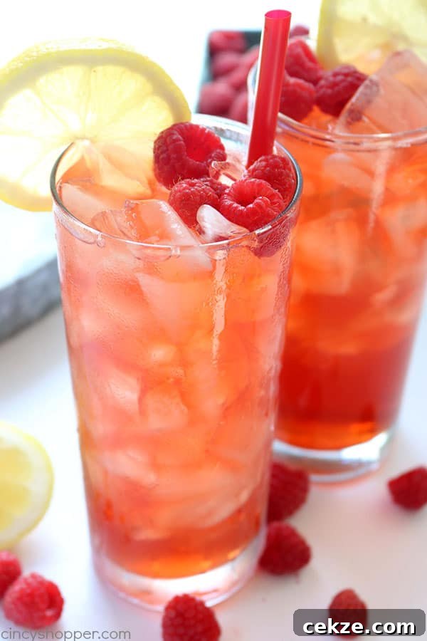 Raspberry Iced Tea - glass of iced tea with raspberries and lemon