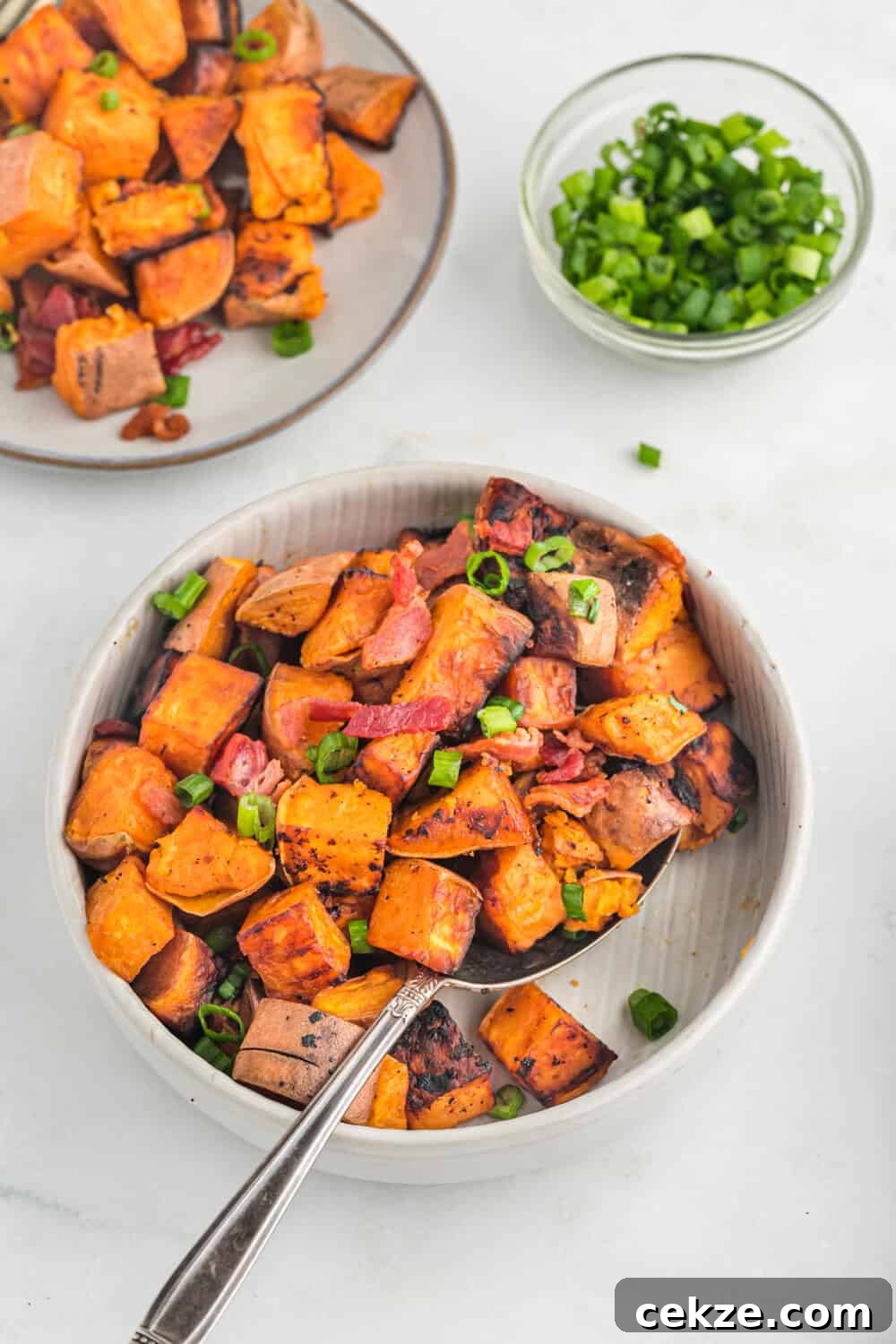 Sweet potato home fries in a pan.