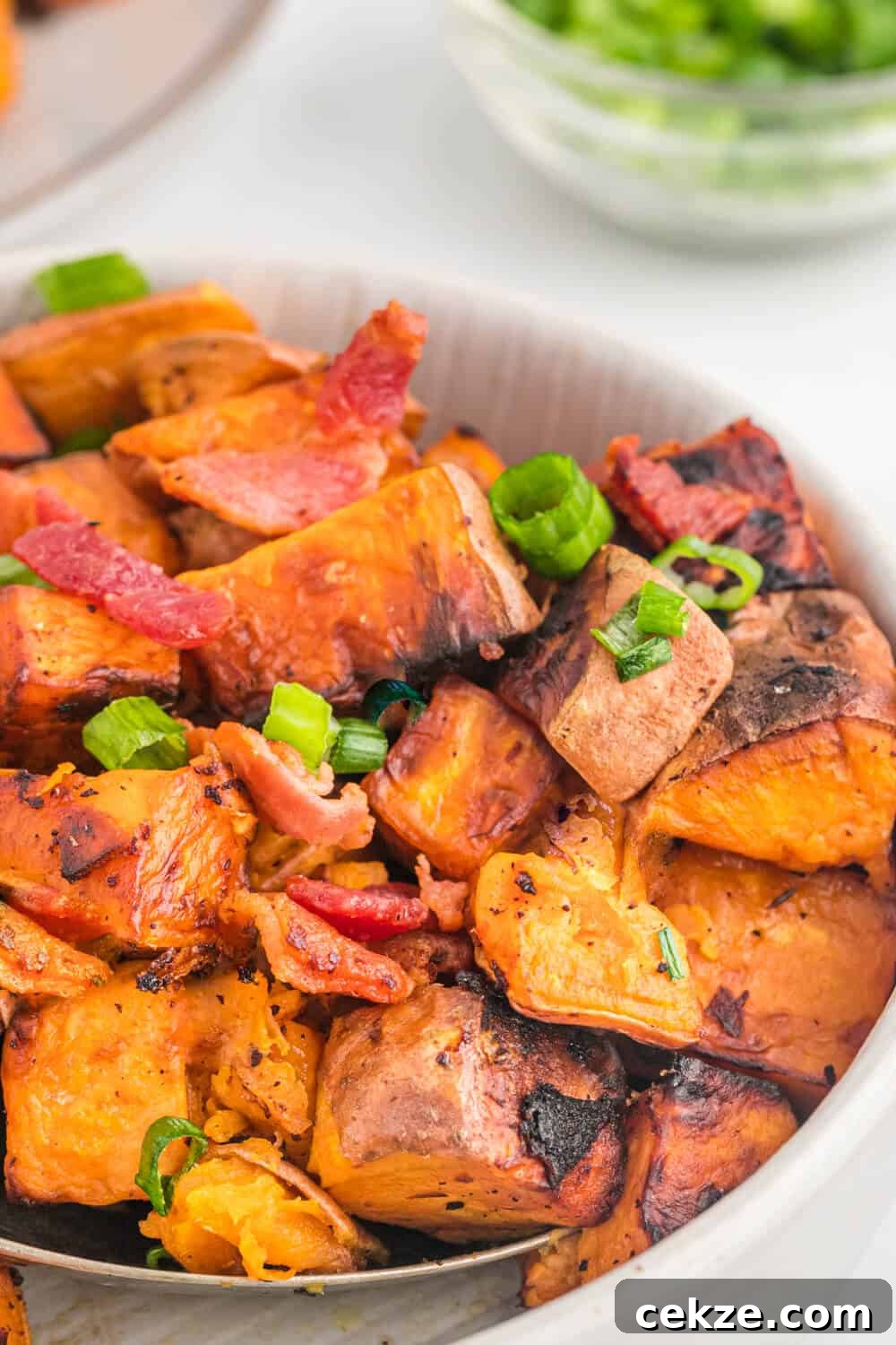 Sweet potato home fries in a pan.