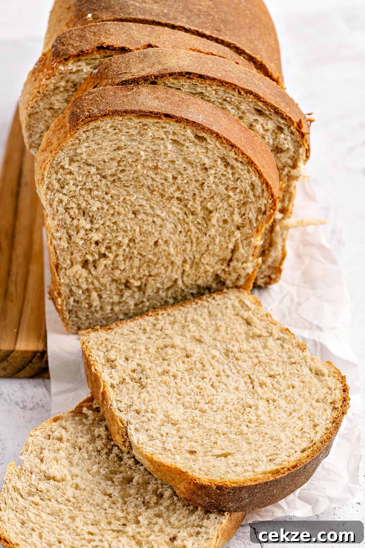 Homestyle Whole Wheat Sandwich Bread Recipe for Families 2 Sliced whole wheat sandwich bread on a white background.
