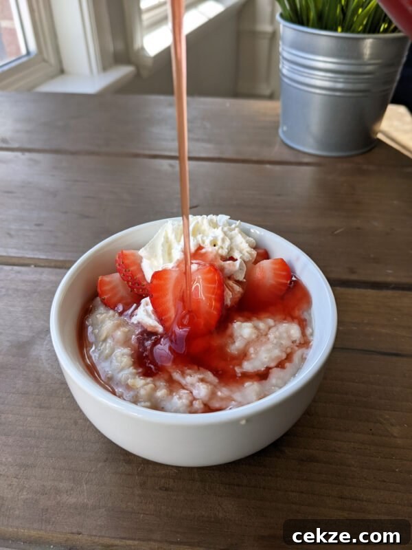 Strawberry Oatmeal with Syrup Pouring Vertical