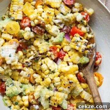 Summer grilled corn and avocado Salad with cherry tomatoes and charred shishito peppers, topped with creamy ranch dressing.