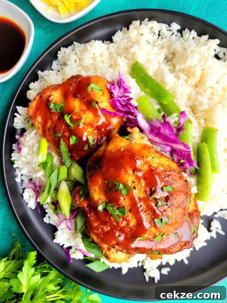 Slow Cooker Asian Chicken Thighs are sticky, sweet, and savory with garlic, ginger, soy sauce, and Sriracha. This easy crockpot chicken recipe is fall-apart tender, better than takeout, and perfect for busy weeknight dinners or meal prep.