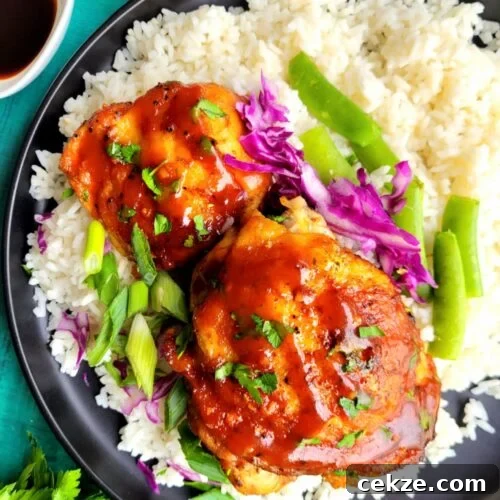 Slow Cooker Asian Chicken Thighs are sticky, sweet, and savory with garlic, ginger, soy sauce, and Sriracha. This easy crockpot chicken recipe is fall-apart tender, better than takeout, and perfect for busy weeknight dinners or meal prep.