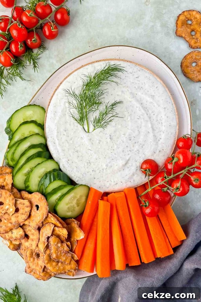 Feta, Bacon & Date Dip Recipe: Sweet Savory Party Appetizer 11 cottage cheese ranch dip with fresh dill as garnish on plate with cucumbers, carrots and pretzels.