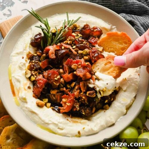 Feta, Bacon & Date Dip Recipe: Sweet Savory Party Appetizer 13 serving bowl with whipped feat cheese topped with a date, bacon, pistachio mixture garnished with rosemary.