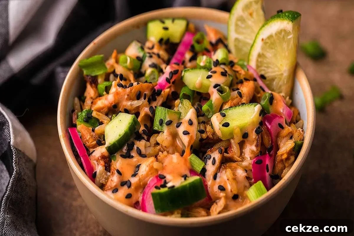 49 TikTok Recipes That Truly Live Up to the Hype 2 A bowl of salmon poke style, topped with cucumbers, pickled onions, black sesame seeds, and lime wedges.
