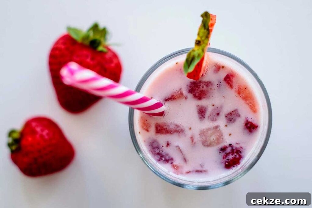 49 TikTok Recipes That Truly Live Up to the Hype 45 Overhead shot of Korean strawberry milk with chunks of strawberries in a glass with a straw
