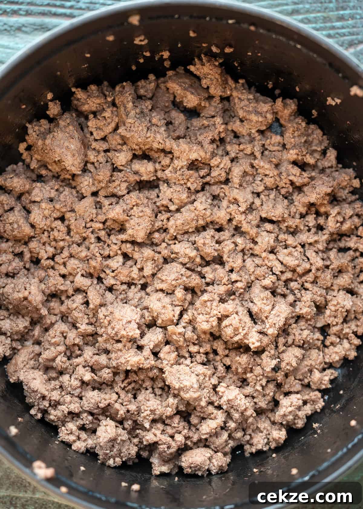 Cabbage and Beef Hamburger Soup Recipe for Comforting Meals 3 browned beef in a black dutch oven