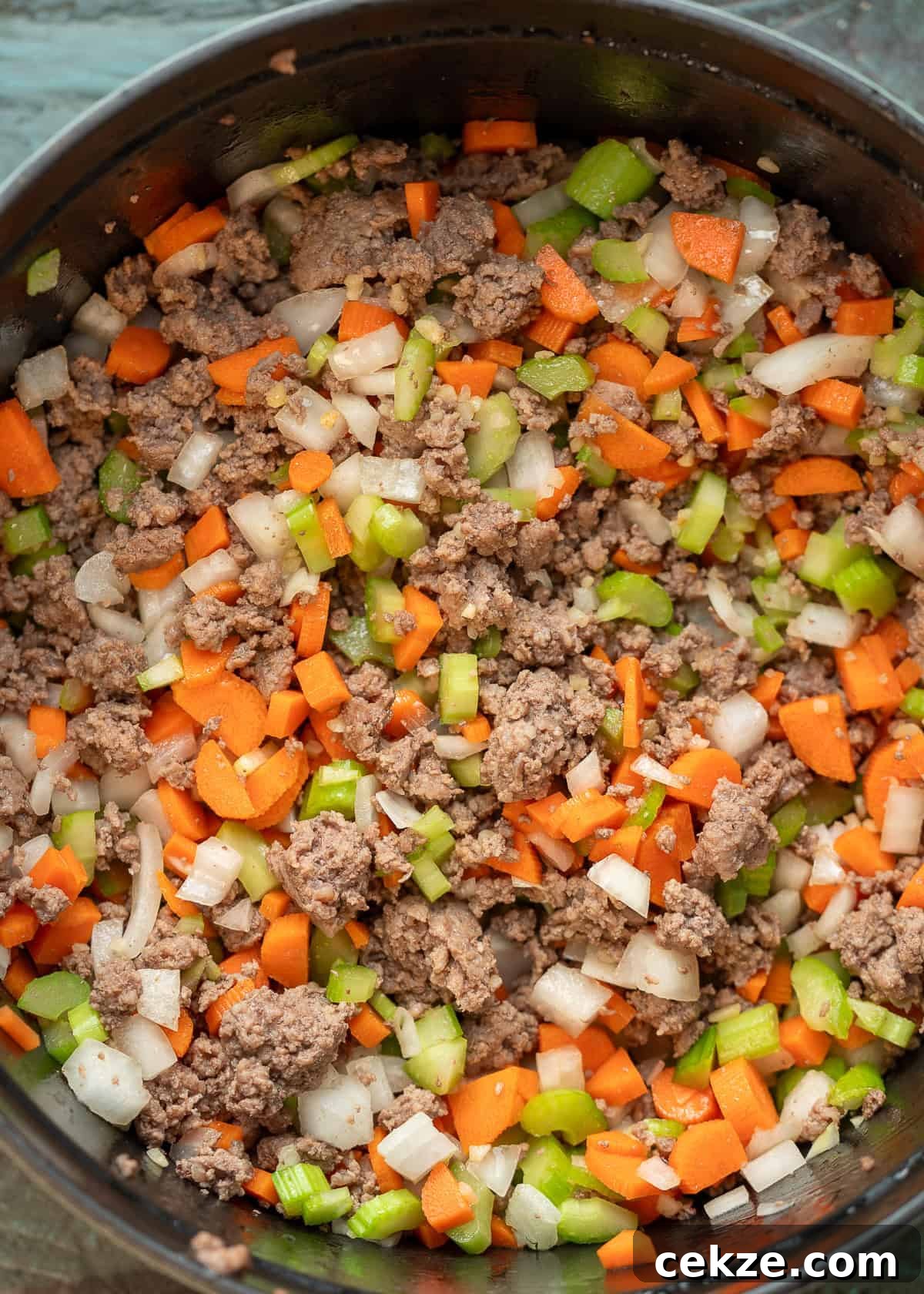 Cabbage and Beef Hamburger Soup Recipe for Comforting Meals 4 browned beef and cooked veggies in a black dutch oven