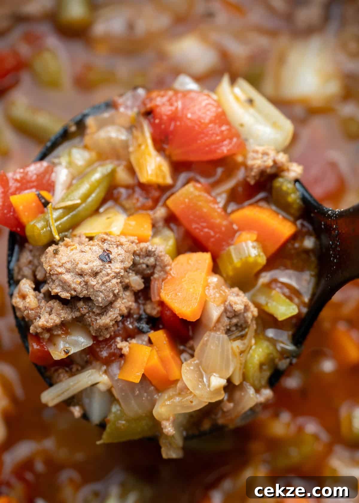 Cabbage and Beef Hamburger Soup Recipe for Comforting Meals 7 close up image of a spoonful of cooked cabbage soup with hamburger