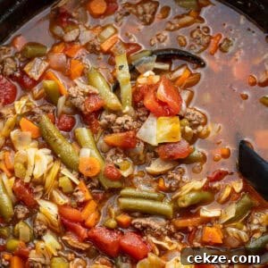 Cabbage and Beef Hamburger Soup Recipe for Comforting Meals 8 overhead image of hamburger soup with cabbage in black dutch oven