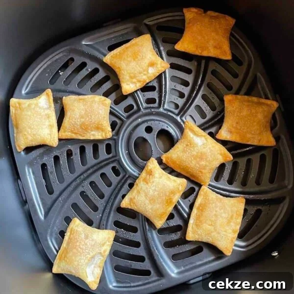Cooked pizza bites in the basket of a Gourmia Air Fryer.