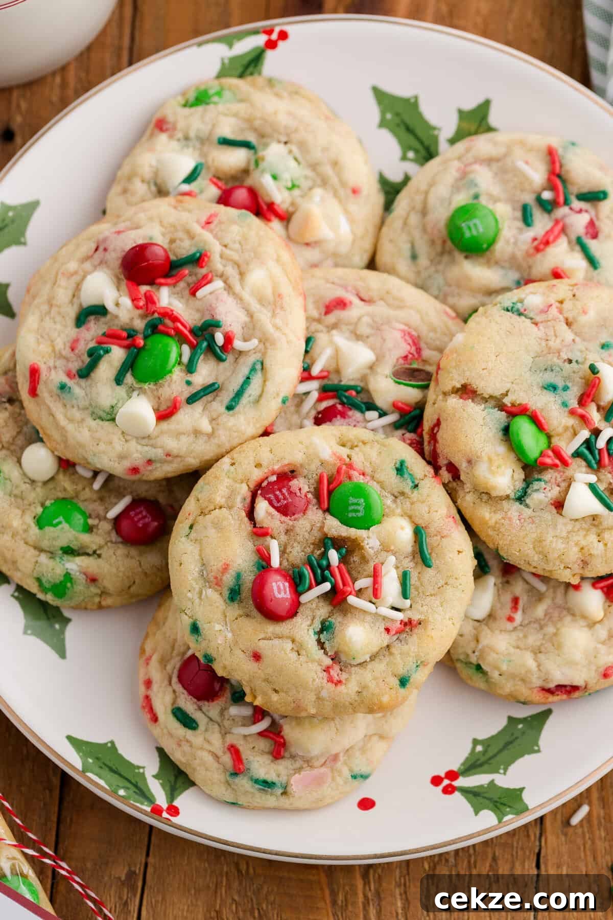 Break-and-Bake Christmas Cookie Dough Tips for Perfect Cookies 5 A plate of festive Christmas cookies with red and green M&Ms, white chocolate chips, and red, green, and white sprinkles.