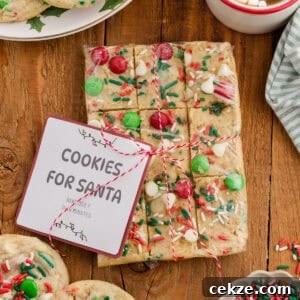 Break-and-Bake Christmas Cookie Dough Tips for Perfect Cookies 6 Wrapped break and bake Christmas cookie dough with festive toppings and a “Cookies for Santa” label.