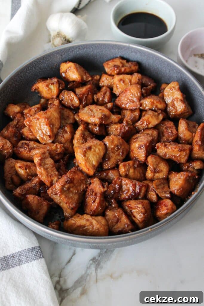 Cooked honey garlic chicken cubes in a grey bowl