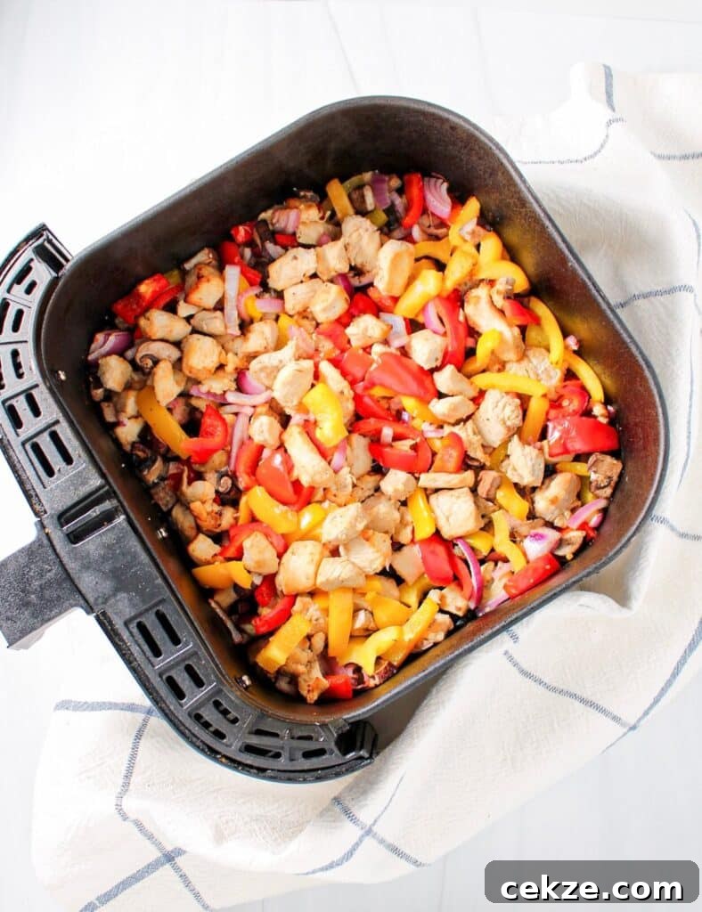 Chicken and vegetable stir fry in an air fryer.