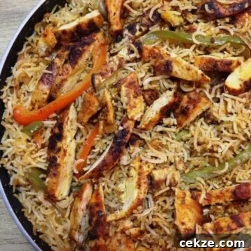 chicken fajita and rice in a skillet.