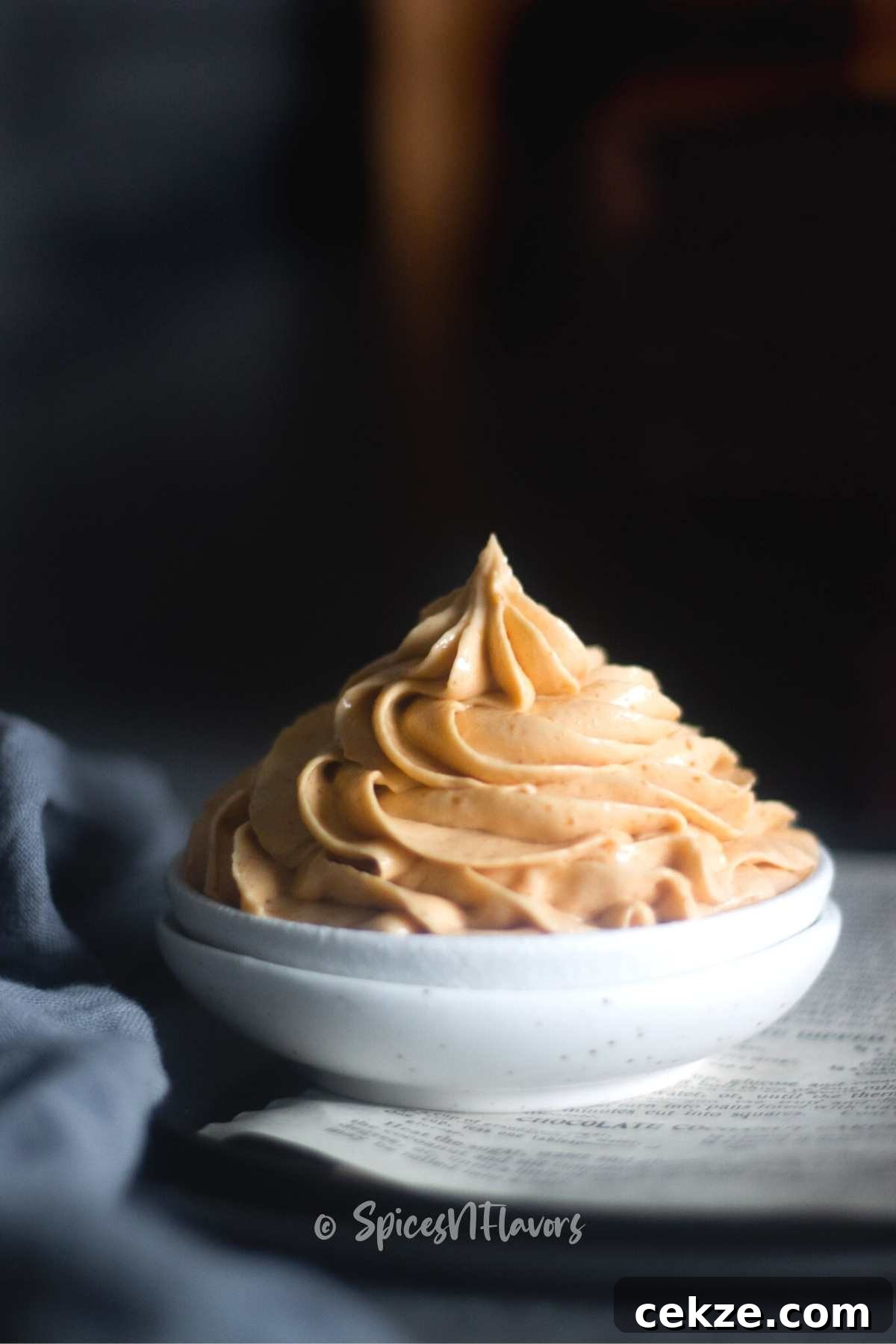Peanut Butter and Cream Cheese Frosting (No Butter) 2 swirl of peanut butter cream cheese frosting piped on a small white bowl