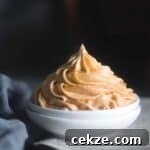 Peanut Butter and Cream Cheese Frosting (No Butter) 7 cropped image of the frosting piped on white bowl to fit the recipe card image