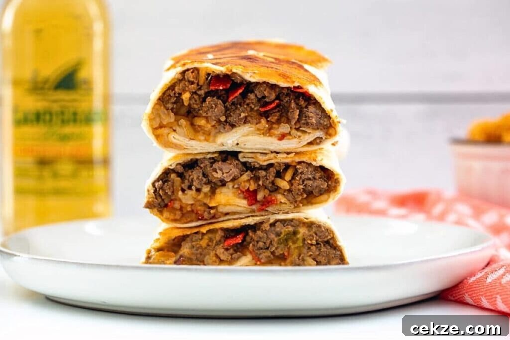 A pile of grilled cheese burritos, sliced in half and stacked.