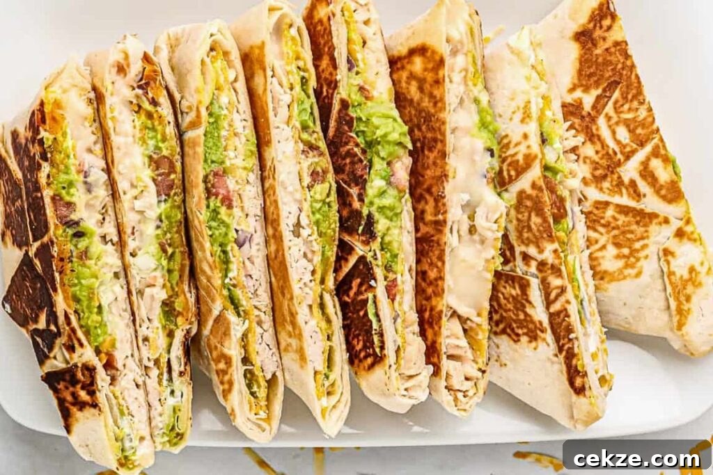 A plate filled with chicken crunch wrap supremes, cut in half and stacked.