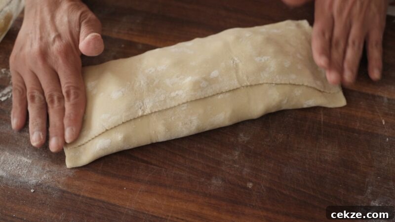 Rolled puff pastry strudel filled with apple and walnut mixture