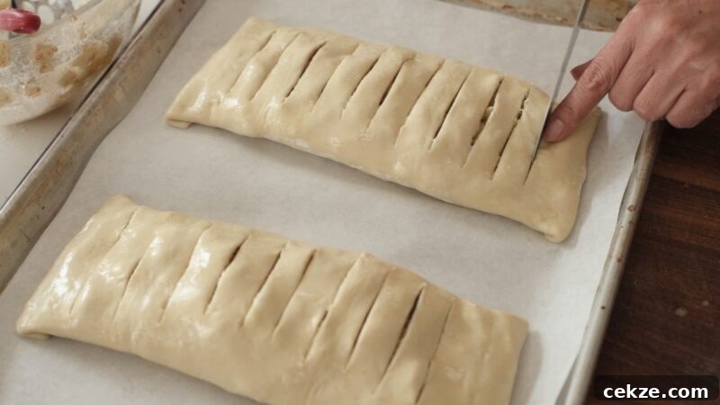 Making slits on puff pastry apple strudel to allow steam to escape