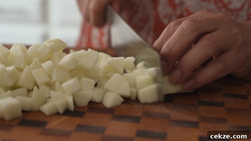 Chopping peeled apple into small pieces for apple strudel filling