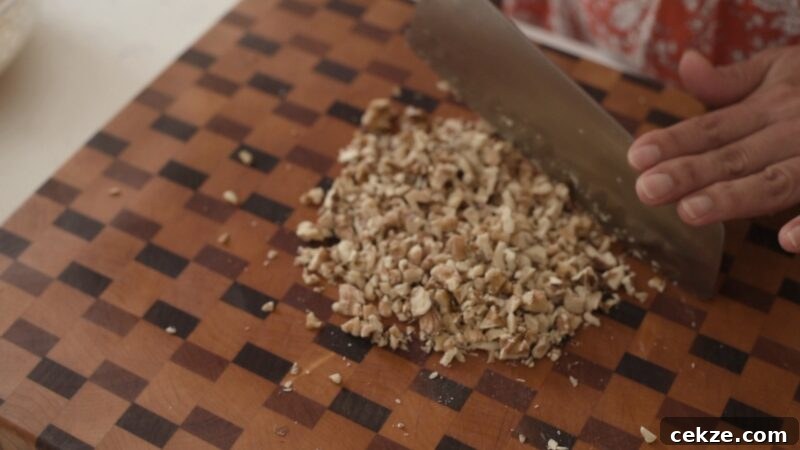 Finely chopping walnuts with a knife for the strudel filling