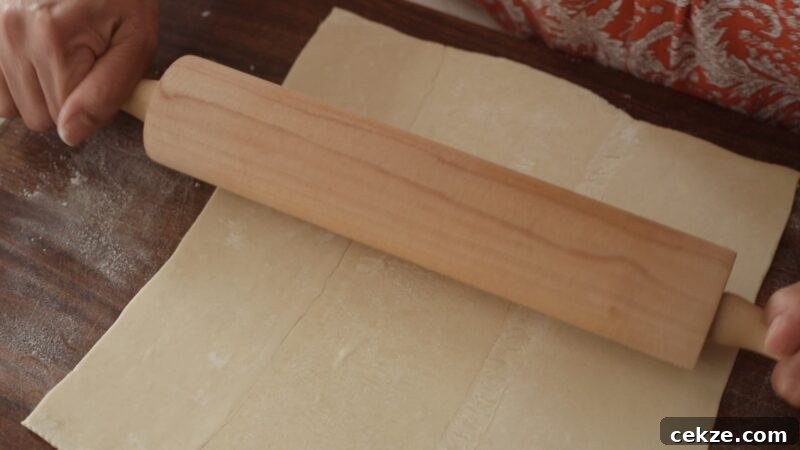 Rolling out puff pastry dough with a rolling pin