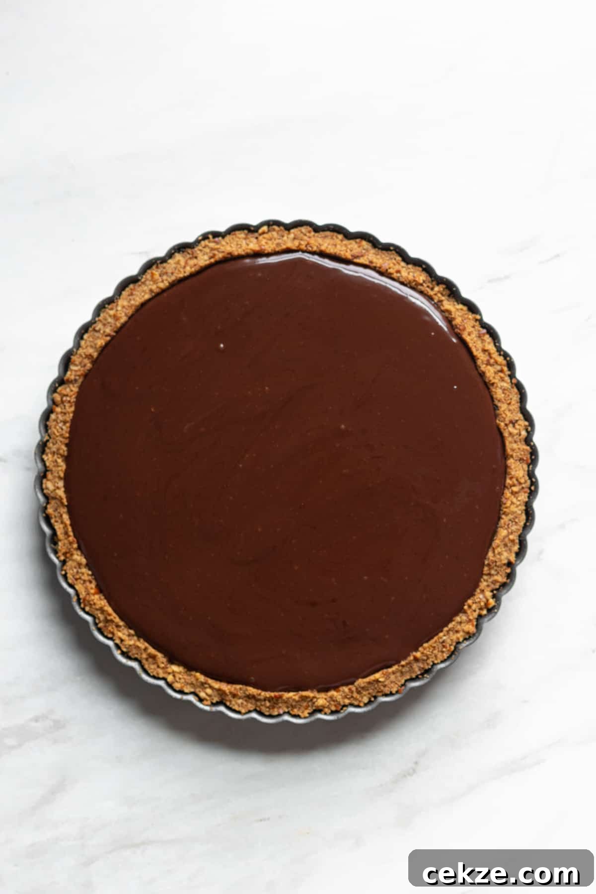 Overhead shot of chocolate ganache set on top of the pie.