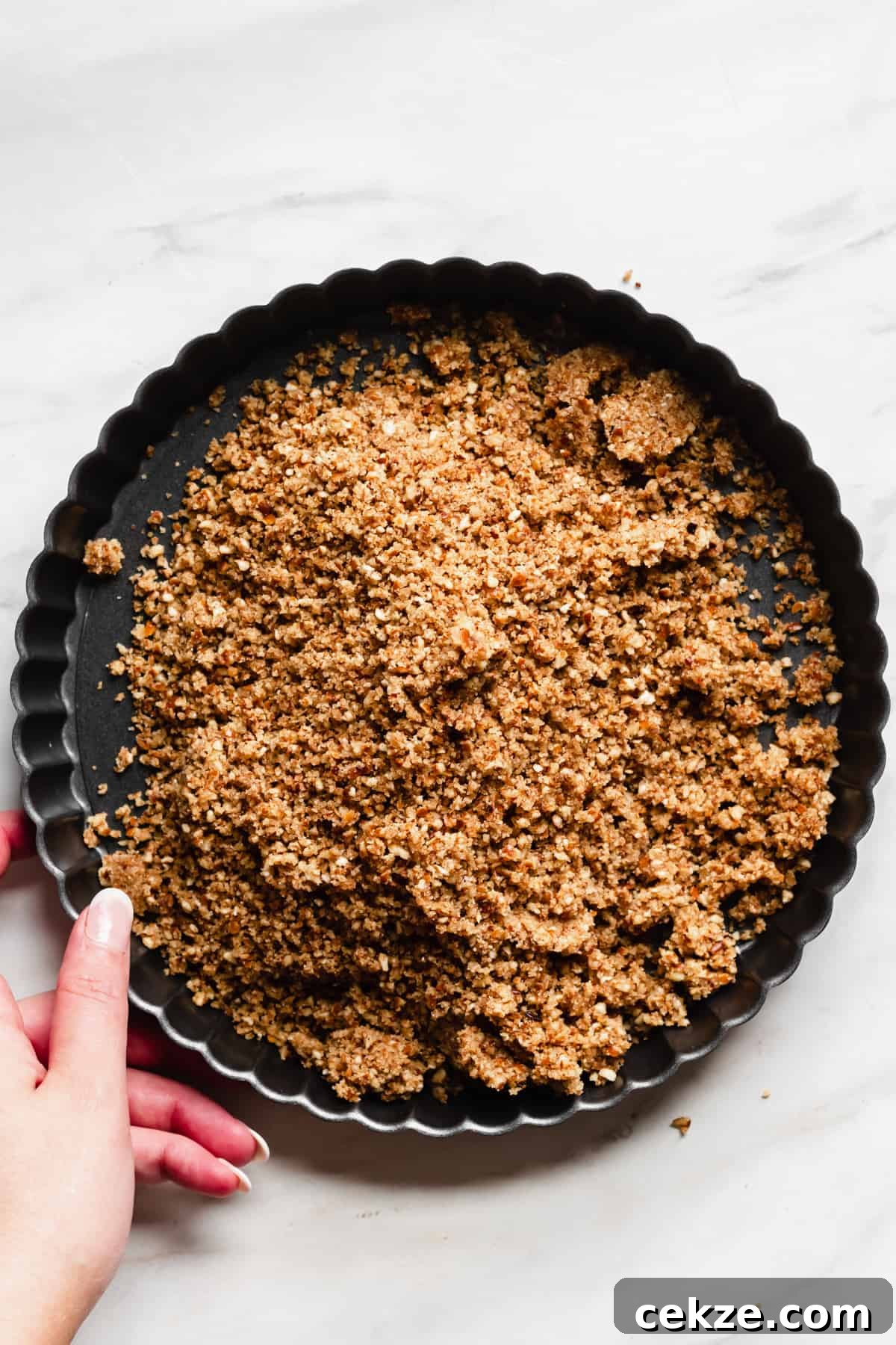 Pretzel crumbs in a tart pan